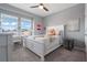 Comfortable bedroom with large window, desk, and a cozy bed at 10814 Whitland Grove Dr, Riverview, FL 33578