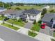 Aerial view of a well landscaped home with a two car garage and a paved driveway with a red car at 10814 Whitland Grove Dr, Riverview, FL 33578