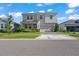 The property features a symmetrical facade, complemented by manicured lawn and shrubbery at 10814 Whitland Grove Dr, Riverview, FL 33578