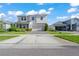 The house showcases a symmetrical facade, accented by tasteful landscaping and a brick paver driveway at 10814 Whitland Grove Dr, Riverview, FL 33578