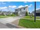 A view of the home's exterior, highlighting the well-kept lawn, brick driveway, and inviting facade at 10814 Whitland Grove Dr, Riverview, FL 33578
