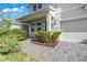 A front entrance features manicured shrubbery, adding to the curb appeal of this home at 10814 Whitland Grove Dr, Riverview, FL 33578