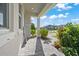 The front porch is paved with stone leading to the front door, with manicured shrubbery nearby at 10814 Whitland Grove Dr, Riverview, FL 33578