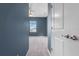 Hallway with blue walls leading to a bedroom with a window view at 10814 Whitland Grove Dr, Riverview, FL 33578