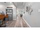 Open hallway with modern decor, wood floors, and seamless transition to the adjacent living spaces at 10814 Whitland Grove Dr, Riverview, FL 33578