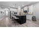 Open kitchen design with stainless steel appliances, large island, and sleek white cabinetry at 10814 Whitland Grove Dr, Riverview, FL 33578