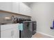 Laundry room with a modern washer and dryer and white cabinets above at 10814 Whitland Grove Dr, Riverview, FL 33578