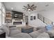Comfortable living room with a stylish fireplace, built-in shelving, and modern staircase at 10814 Whitland Grove Dr, Riverview, FL 33578