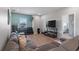 Bright living room with large gray sectional sofa and flat screen television at 10814 Whitland Grove Dr, Riverview, FL 33578