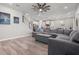 Spacious living room featuring an open floor plan with wood floors, fan and a staircase at 10814 Whitland Grove Dr, Riverview, FL 33578