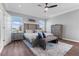A well-lit main bedroom with neutral decor, wood-look floors, and a decorative bench at 10814 Whitland Grove Dr, Riverview, FL 33578