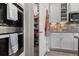 View into a fully stocked pantry adjacent to built-in double ovens in this home at 10814 Whitland Grove Dr, Riverview, FL 33578