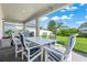 Outdoor patio with dining set, grill, and lush green lawn surrounded by fencing and greenery at 10814 Whitland Grove Dr, Riverview, FL 33578