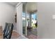 A view of the patio through sliding glass doors reveals a well-equipped outdoor cooking area at 10814 Whitland Grove Dr, Riverview, FL 33578