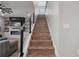 A staircase with wooden treads and modern metal railing leads to the upper level at 10814 Whitland Grove Dr, Riverview, FL 33578