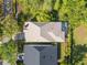 Aerial view showcasing the home's roof, screened pool, landscaping, and proximity to neighboring houses at 11611 Meridian Point Dr, Tampa, FL 33626