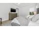 Spacious bedroom with tray ceiling, large dresser, and plush bedding at 11611 Meridian Point Dr, Tampa, FL 33626