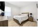 Bright bedroom features a cozy bed, wood-look floors, and a large window providing ample natural light at 11611 Meridian Point Dr, Tampa, FL 33626