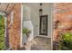 Brick-paved entryway featuring a decorative brick wall and potted plant at 11611 Meridian Point Dr, Tampa, FL 33626