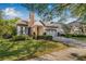Charming single-Gathering home featuring brick accents, manicured landscaping, and a two-car garage at 11611 Meridian Point Dr, Tampa, FL 33626