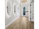 Bright hallway featuring modern lit mirrors and a glass paneled front door at 11611 Meridian Point Dr, Tampa, FL 33626