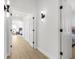 Hallway featuring modern light fixtures, doors, and entrance to a bedroom at 11611 Meridian Point Dr, Tampa, FL 33626