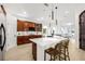 Bright, open kitchen with wood cabinets, stainless steel appliances, and a large center island with pendant lighting at 11611 Meridian Point Dr, Tampa, FL 33626
