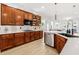 Stylish kitchen with dark wood cabinets, stainless steel appliances, and a view into the adjacent living area at 11611 Meridian Point Dr, Tampa, FL 33626