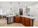 View of kitchen with large island, sink, dishwasher and wine cellar that opens to the living area at 11611 Meridian Point Dr, Tampa, FL 33626