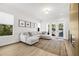 Bright living room with a large sectional sofa, modern artwork, and access to outdoor pool at 11611 Meridian Point Dr, Tampa, FL 33626