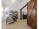 Bright room featuring a chair, bookcase, wood floors and barn doors at 11611 Meridian Point Dr, Tampa, FL 33626