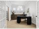 Bright office featuring modern desk, elegant sideboard and wood floors at 11611 Meridian Point Dr, Tampa, FL 33626