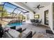 Relaxing screened-in pool area with lounge chairs, ceiling fan, and a stone waterfall feature at 11611 Meridian Point Dr, Tampa, FL 33626
