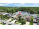 Scenic aerial view of a home near a tranquil lake, surrounded by lush greenery at 11712 Winterset Cove Dr, Riverview, FL 33579