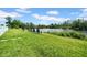 Inviting backyard featuring lawn chairs by the lake, perfect for relaxation and enjoying the outdoors at 11712 Winterset Cove Dr, Riverview, FL 33579