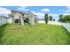 Lush backyard features a play structure, offering ample space for outdoor activities and entertainment at 11712 Winterset Cove Dr, Riverview, FL 33579