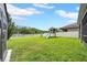 Expansive backyard with a lake view, showcasing a playset and privacy fence for Gathering enjoyment at 11712 Winterset Cove Dr, Riverview, FL 33579