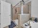 Modern bathroom features a shower behind glass, soaking tub, and neutral walls at 11712 Winterset Cove Dr, Riverview, FL 33579