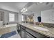 The bathroom features granite countertops, dual sinks, an ensuite bath, and modern fixtures at 11712 Winterset Cove Dr, Riverview, FL 33579