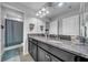 Modern bathroom features granite countertops, dual sinks, an ensuite bath, and tiled flooring at 11712 Winterset Cove Dr, Riverview, FL 33579