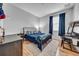 Bedroom featuring a blue comforter, desk, hardwood floors, natural light, and gray walls at 11712 Winterset Cove Dr, Riverview, FL 33579