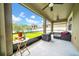 Relaxing covered patio features ceiling fans, outdoor seating, and a view of the lush backyard and playground at 11712 Winterset Cove Dr, Riverview, FL 33579