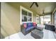 Cozy covered patio with comfortable seating, ceiling fans, and a serene outdoor ambiance at 11712 Winterset Cove Dr, Riverview, FL 33579