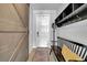 Foyer featuring a wooden sliding door, bench with pillow, and hooks with storage shelf at 11712 Winterset Cove Dr, Riverview, FL 33579