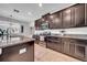 Well-lit kitchen featuring dark cabinetry, granite countertops, stainless steel appliances, and tile flooring at 11712 Winterset Cove Dr, Riverview, FL 33579