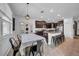Open concept kitchen with dark wood cabinetry, granite countertops, plus dining area with table at 11712 Winterset Cove Dr, Riverview, FL 33579