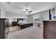 The main bedroom includes a ceiling fan, large window, and dark wood furniture at 11712 Winterset Cove Dr, Riverview, FL 33579