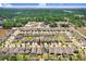 Drone shot showcases neighborhood with neatly arranged homes, mature trees, and vibrant green lawns at 1214 Florablu Dr, Seffner, FL 33584