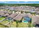 Aerial view of a neighborhood showcasing houses with pools and well-maintained landscaping at 1214 Florablu Dr, Seffner, FL 33584