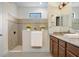 Bright bathroom offers a glass enclosed shower, neutral tile and granite vanity with abundant counter space at 1214 Florablu Dr, Seffner, FL 33584